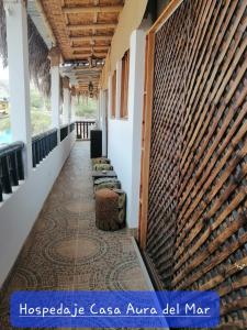 a corridor of a building with a row of chairs at Casa Aura Del Mar in Máncora