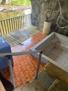 a porch with a wooden floor and a wooden table at Cabinas Valle Azul in San Ramón