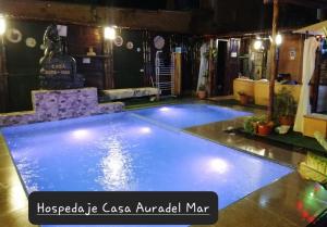 a large swimming pool in a room at Casa Aura Del Mar in Máncora