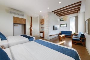 a bedroom with two beds and a living room at Oceanic Pearl Resort in Xiaoliuqiu