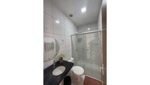a bathroom with a shower and a sink and a toilet at Dunas residence casa 03 in Santo Amaro +73 photos
