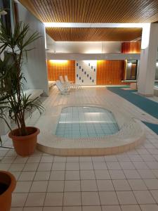 a pool in the middle of a room with chairs and plants at Berolina 125 - Sonnenseite in Dahme