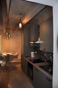 a kitchen with a table and a dining room at Bramante Suites Urbino in Urbino