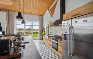 a large kitchen with a stainless steel refrigerator at Stunning Home In Templin With Sauna in Templin