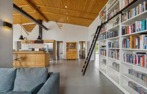 a room with a library with shelves filled with books at Stunning Home In Templin With Sauna in Templin