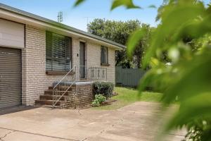 a brick house with a staircase in front of it at So Central, So Comfortable! in Toowoomba