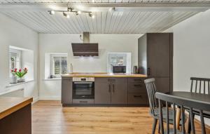 a kitchen with stainless steel appliances and a table at 2 Bedroom Beautiful Home In Waltersdorf in Waltersdorf