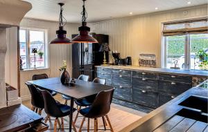 a kitchen with a table and chairs in a room at 3 Bedroom Lovely Home In Alingss in Alingsås