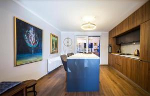 a kitchen with a blue island in a room at Nice Home In Bizovac With Sauna in Bizovac