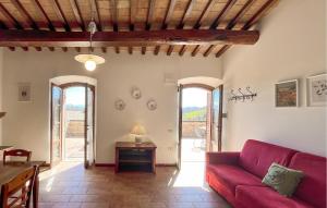 a living room with a red couch and a table at Awesome Apartment In Gubbio With Wifi in Gubbio