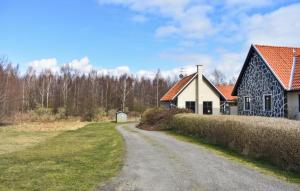 a house and a road next to a house at Stunning Home In Ystad With Kitchen in Ystad