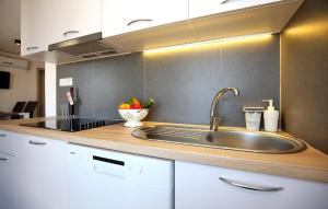 a kitchen with a sink and a counter top at Gorgeous Home In Murter in Murter