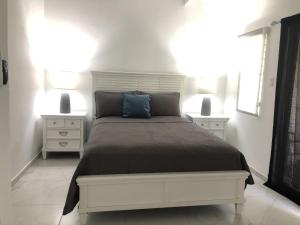 a bedroom with a large bed with two night stands at 101E Jolly Harbour in Jolly Harbour