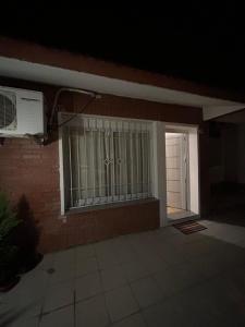 een huis met een raam en een deur met een ventilator bij M&M’s House in Termas de Río Hondo