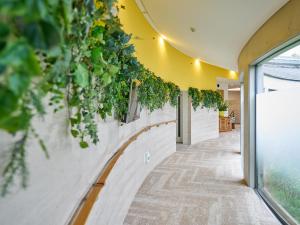 a hallway with plants on the wall at WeBase KAMAKURA in Kamakura +111 photos