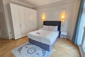 a small bedroom with a bed and a white cabinet at Apartment London Eye& Big Ben.Walk to China Town.Oxford street in London