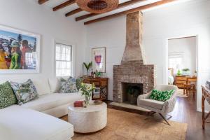 a living room with a couch and a fireplace at Cottage Row at Casa Zoe in Charleston