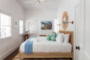 a bedroom with a bed with two pillows on it at Cottage Row at Casa Zoe in Charleston