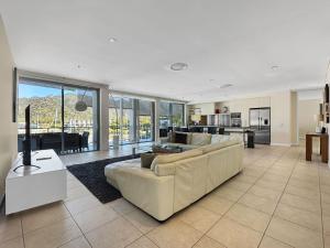 a large living room with a couch and a kitchen at Blue on Blue Penthouse Apartment 335 in Nelly Bay