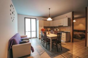 a kitchen and living room with a table and a couch at Agritur il Torchio in Arco