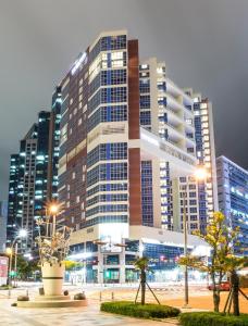 a large building with lights in front of it at Centum Premier Hotel in Busan
