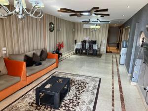 ein Wohnzimmer mit einem Sofa und einem Tisch in der Unterkunft شقة فندقية على النيل مباشر بالمعادى ٣ غرف ٣ حمام in Kairo