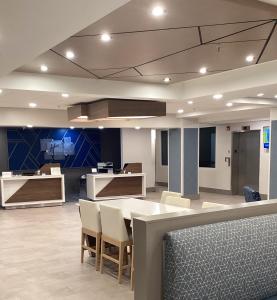 a lobby with a table and chairs in a building at Holiday Inn Express Hotel & Suites Cocoa Beach, an IHG Hotel in Cocoa Beach