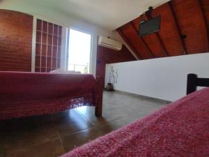 a bedroom with two beds and a window at Cabañas AK Tu Lugar in Potrero de los Funes