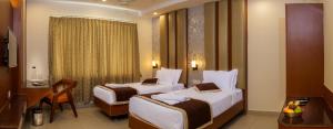 Postel nebo postele na pokoji v ubytování Wyt Hotels - Rameswaram