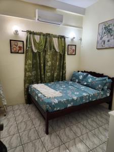 a small bedroom with a bed and a window at Sun Lover's Apartments in The Lime