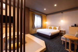 a hotel room with a bed and a crib at Rinn Kyoto Station West in Kyoto