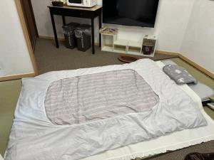 Postel nebo postele na pokoji v ubytování hanamaru-house 民泊一戸建ホテル