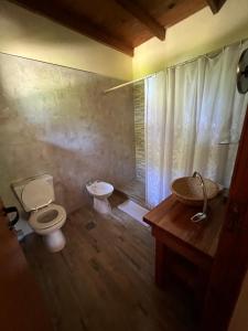 a bathroom with a toilet and a sink at Cabaña en La Caleta in Mar de Cobo +11 photos