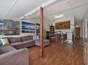 a living room with a couch and a table at Gladstone Backpackers in Gladstone