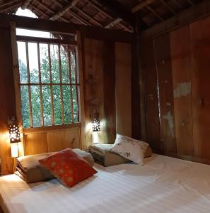 a bedroom with two beds and a window at Mường Trai Homestay in Sơn La