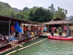 a group of people sitting on a raft in the water at Mường Trai Homestay in Sơn La