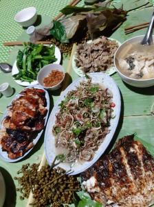 una mesa con muchos platos de comida. en Mường Trai Homestay, en Sơn La
