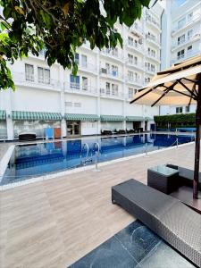 a large building with a swimming pool in front of a building at Country Inn & Suites By Migrolino in Lucknow