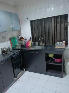 a kitchen with a black counter and a sink at Sommy's place in Abuja