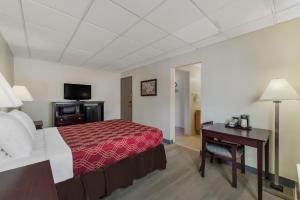 a hotel room with a bed and a desk at Baymont by Wyndham Iron Mountain in Iron Mountain