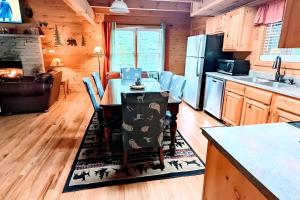 a kitchen and living room with a table in a cabin at Prime Mountain Cabin - Near Galinburg Downtown in Gatlinburg