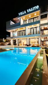 a large building with a swimming pool at night at VILLA VALITO in Kuta Lombok