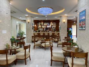 a restaurant with tables and chairs and a bar at Nguyễn Quyền Hotel in Hanoi
