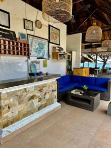 a lobby with a blue couch and a counter at Nusa Indah Bungalow in Nusa Lembongan
