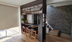 a bar in a room with a brick wall at Golden Dune Escape in Mount Maunganui