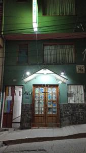 a building with an umbrella over the front doors at TAWA INTI HOSTEL in Puno