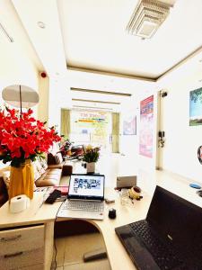 an office with a desk with two laptops on it at MyMy Motel in Da Nang