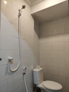 a bathroom with a shower with a toilet at Ega S Hostel in Nusa Penida