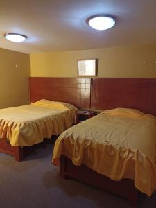 Postel nebo postele na pokoji v ubytování TAWA INTI HOSTEL