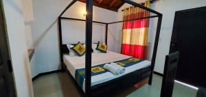 a bedroom with two bunk beds in a room at Surf And Stay Arugam Bay in Arugam Bay